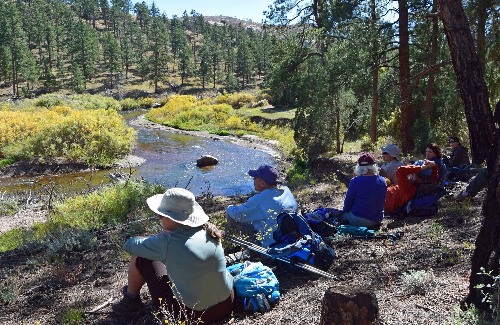 Hikers sitting on bank above S Platte River